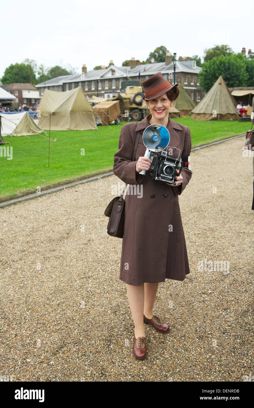 Chatham, UK. 21st Sep, 2013. Salute to the 40's - Britain's 1940's Home Front Event at The Historic Dockyard Chatham. Female press photographer with military encampment in the background. woman with camera 1950s Stock Photo