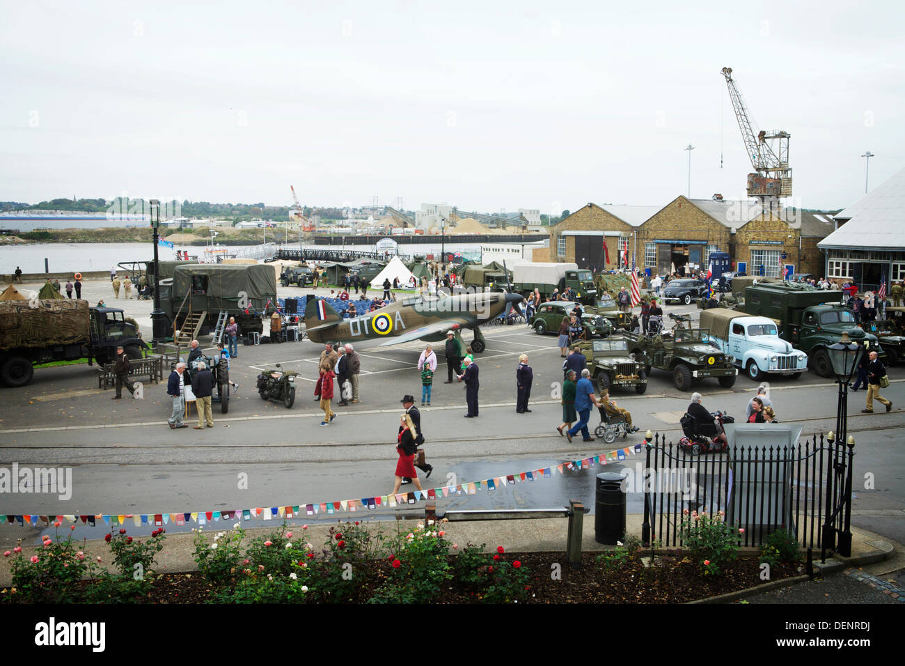 Chatham, UK. 21st Sep, 2013. Salute to the 40's - Britain's 1940's Home Front Event at The Historic Dockyard Chatham.  View of American military vehiicles, a Spitfire plane, warehouses, docks and people attending the event. Credit:  Tony Farrugia/Alamy Live News Stock Photo