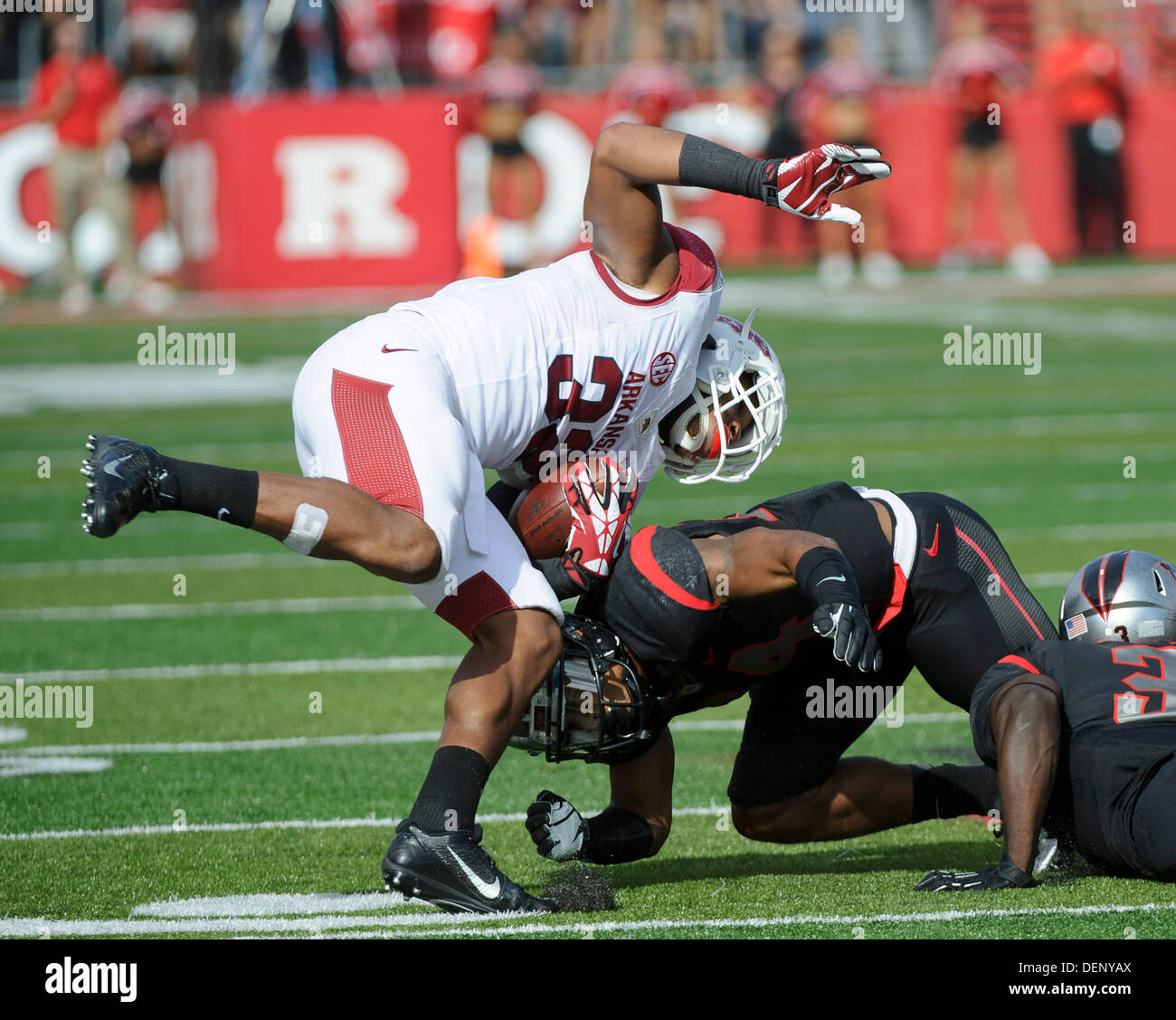 Piscataway, New Jersey, USA. 21st Sep, 2013. September 21, 2013: Rutgers Scarlet Knights defensive back Lew Toler (24) hits Arkansas Razorbacks running back Jonathan Williams (32) at the knees during the game between Arkansas Razorbacks and Rutgers Scarlet Knights at Highpoint Solutions Stadium in Piscataway, NJ. Rutgers Scarlet Knights defeated The Arkansas Razorbacks 28-24. Credit:  csm/Alamy Live News Stock Photo