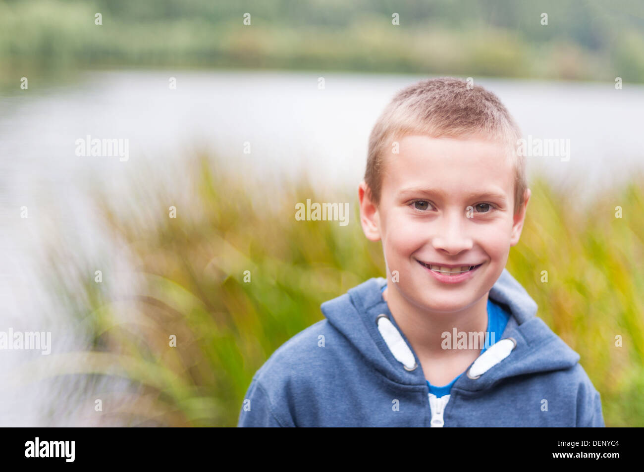 Adorable boy with retainer on teeth smiling outdoors Stock Photo