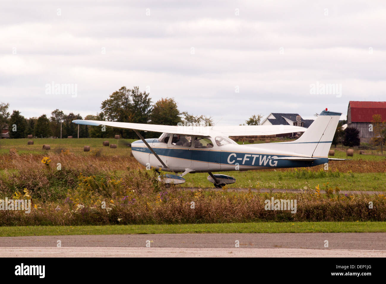 Small plane landing at Lindsay Kawartha Lakes airport. Stock Photo