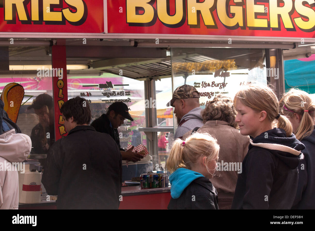 People in line to buy Burgers and French Fries at food vendor at Lindsay Fair and Exhibition in Kawartha Lakes Stock Photo