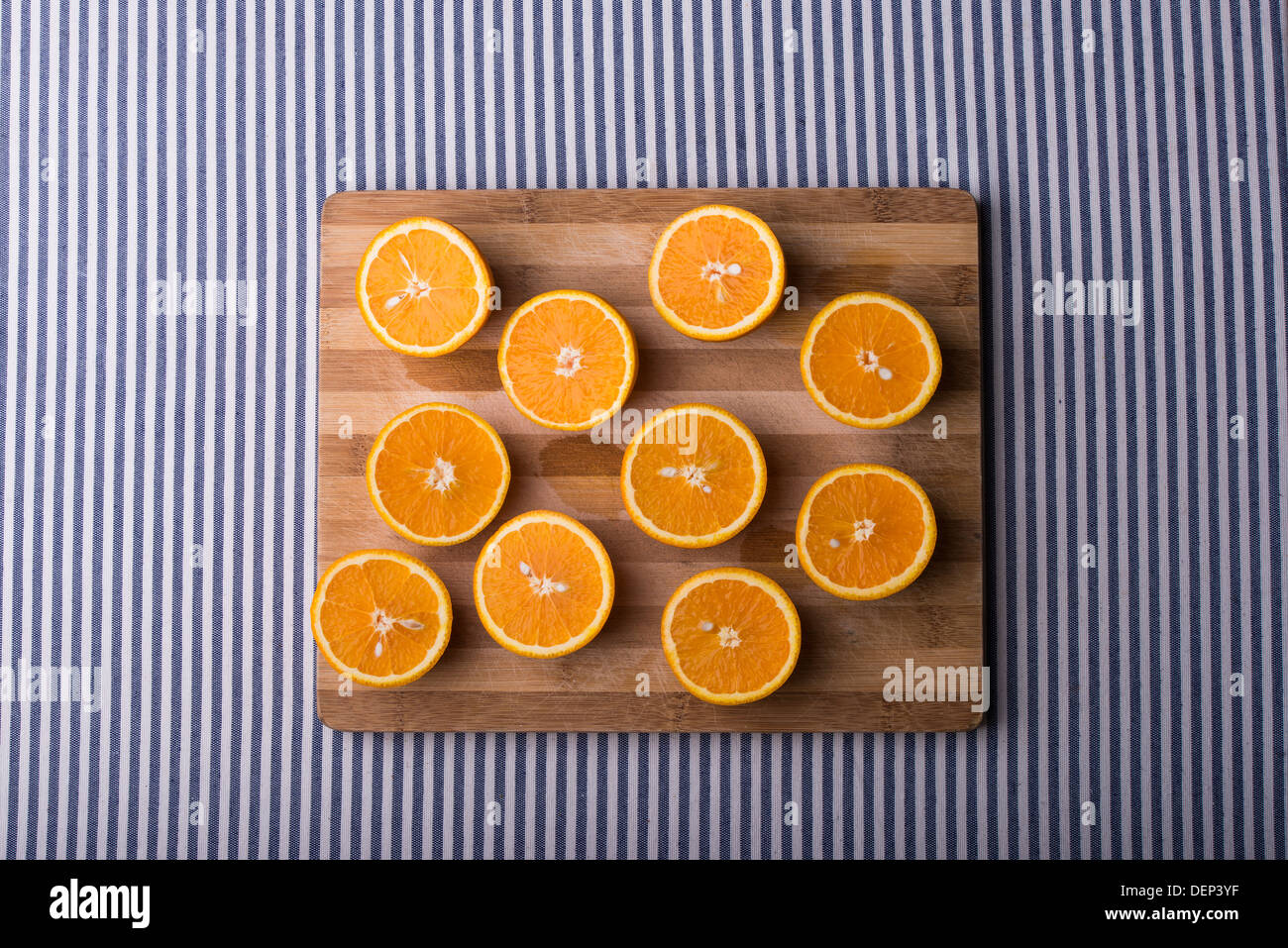 oranges on a wooden plate with blue white table runner Stock Photo