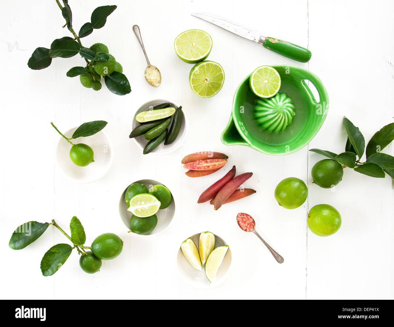 A variety of different limes in different states of preparation; including tahitian, kaffir and finger limes. Stock Photo