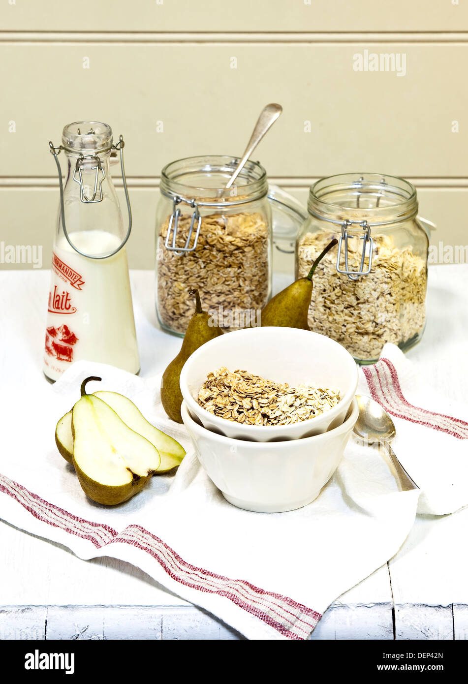 A variety of items making up a low G.I. breakfast of museli, oats, milk and pear. Stock Photo