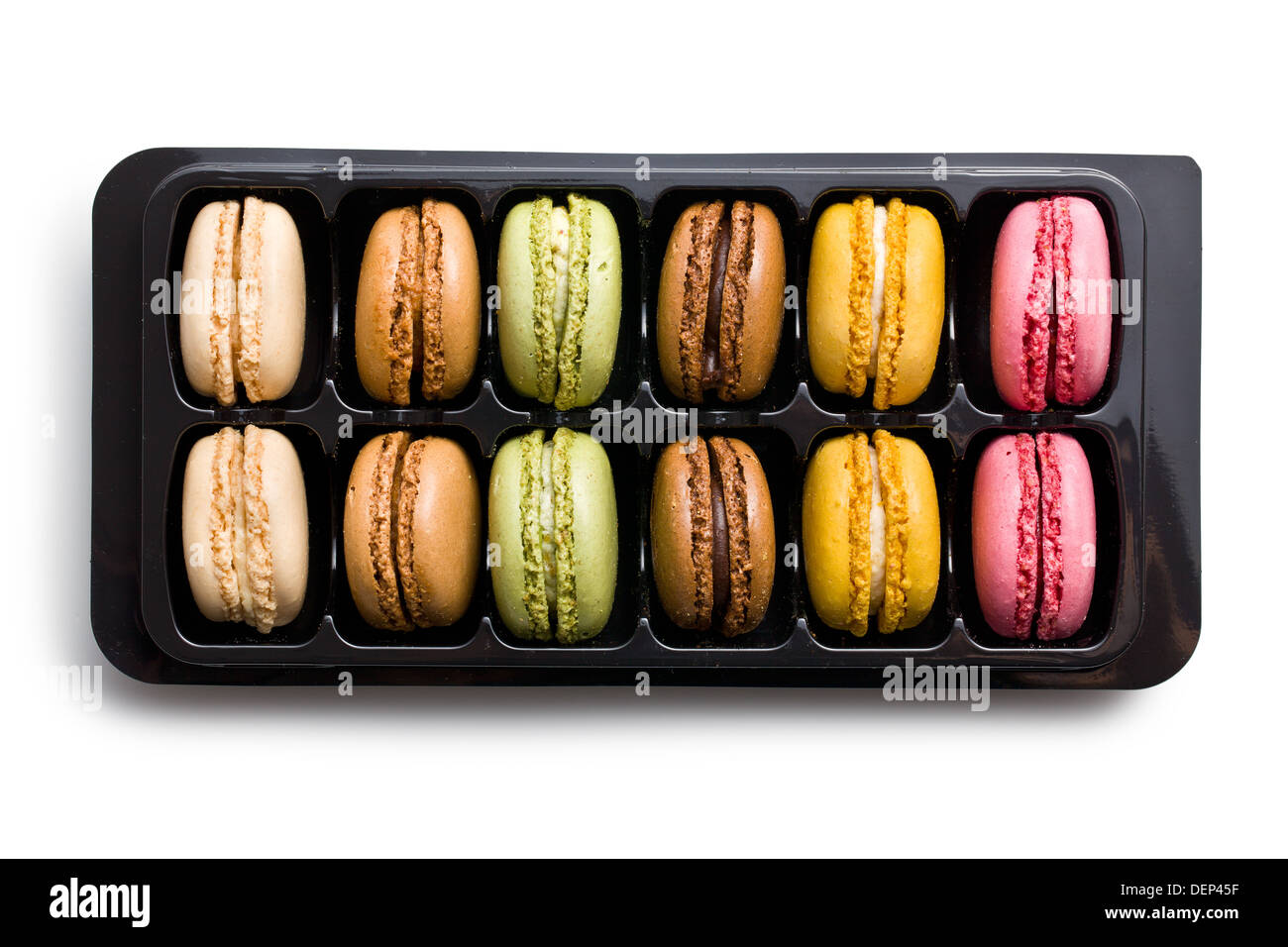 colorful macaroons in plastick box on white background Stock Photo