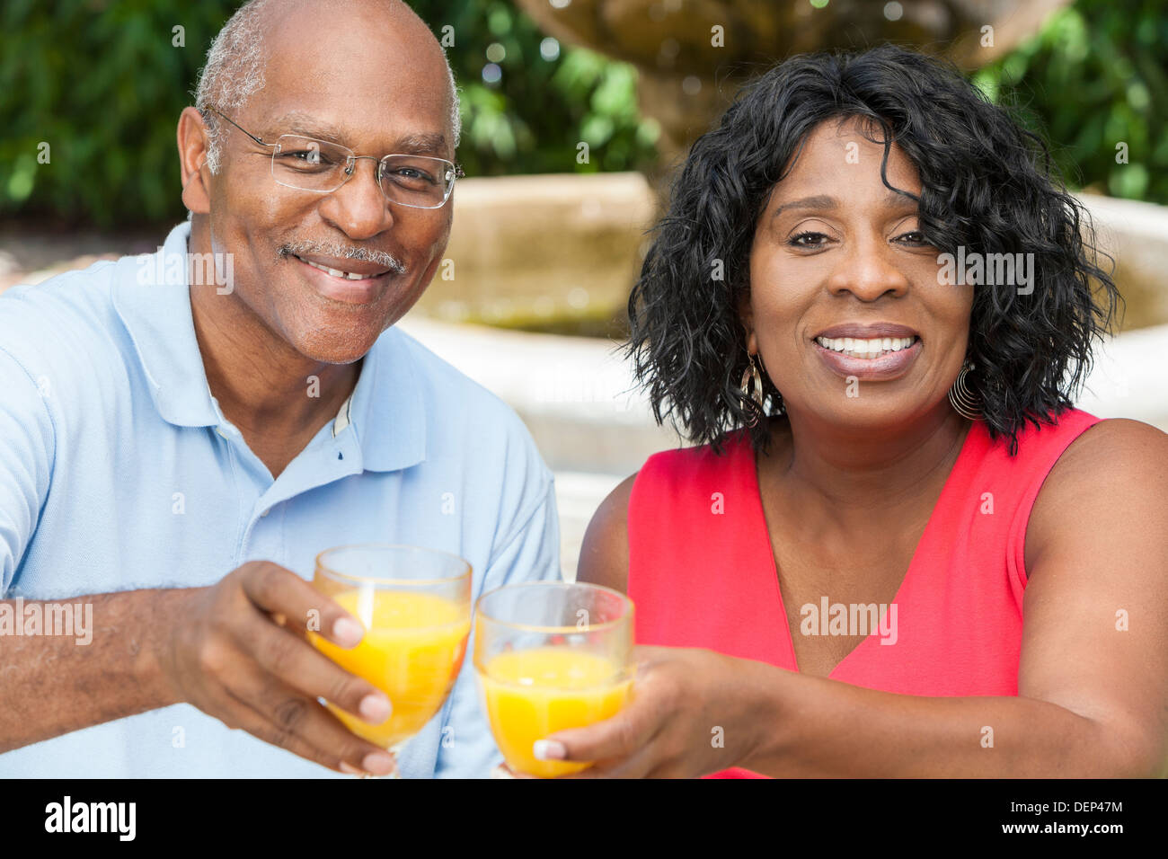 A happy, smiling man and woman senior African American couple outside ...