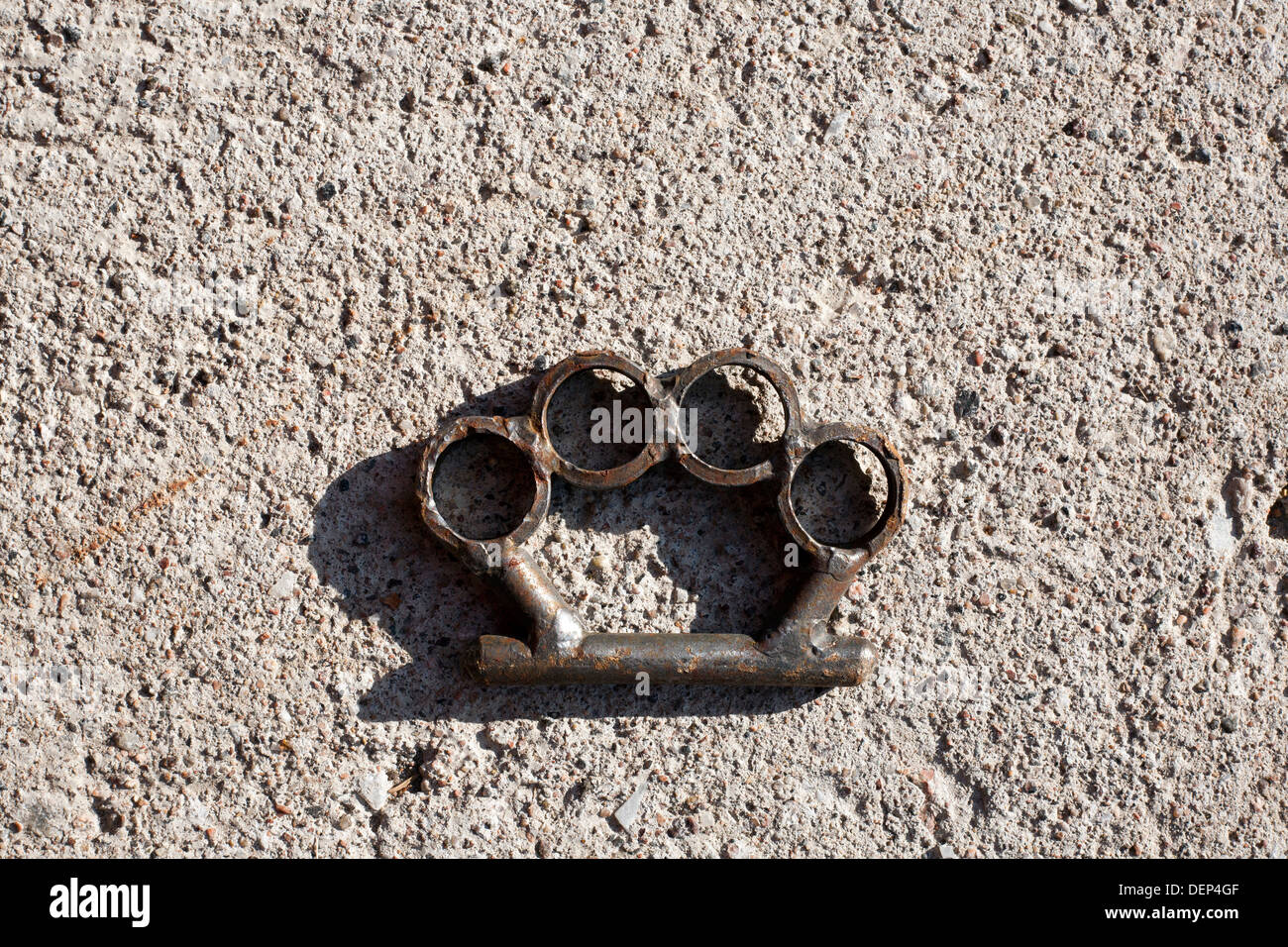 brass knuckles on ground Stock Photo Alamy