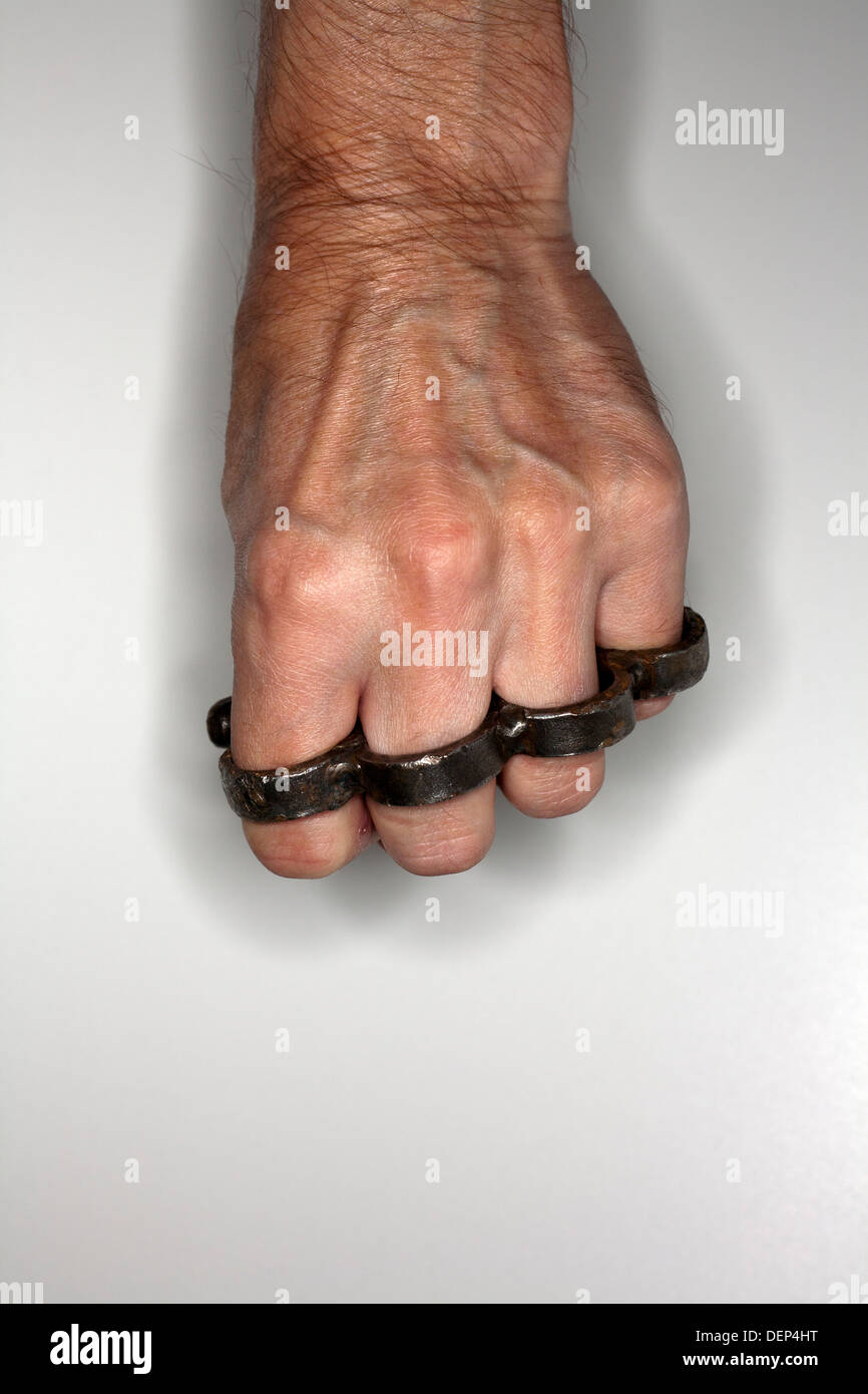 Blow with Brass Knuckles. the Hand of an Elderly Woman Clutches a