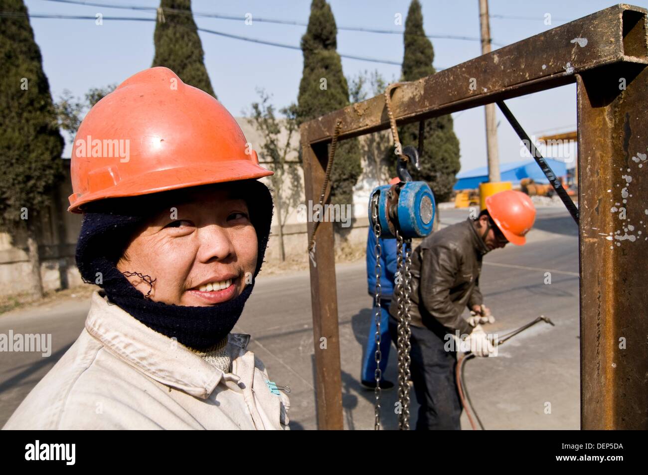 Chinese construction workers wearing protection gear on their heads