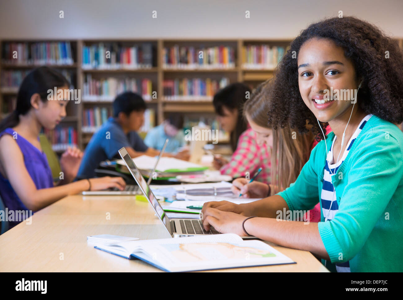 Student using laptop in library Stock Photo