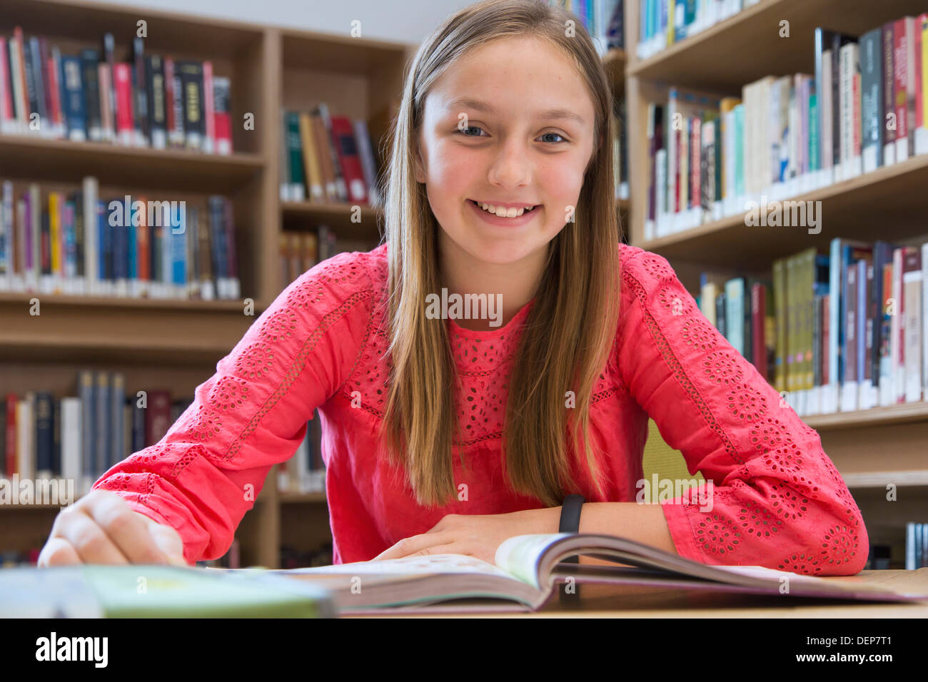 Caucasian student smiling in library Stock Photo