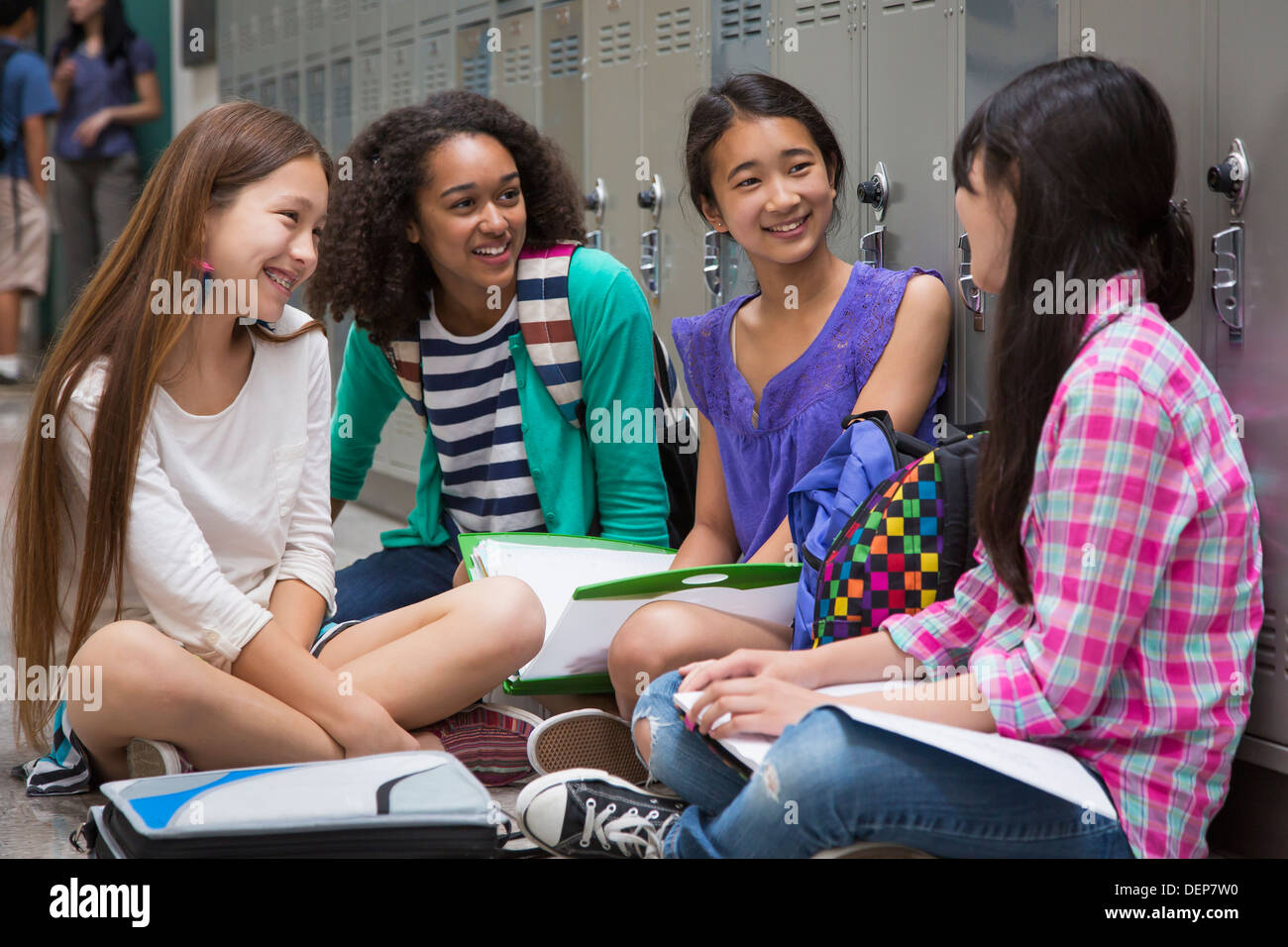 Students talking in school corridor Stock Photo