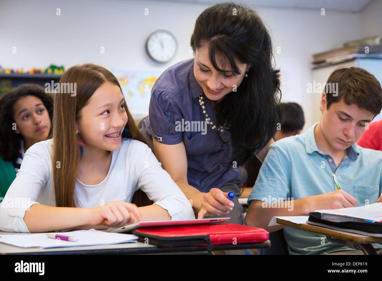 Teacher helping students in class Stock Photo