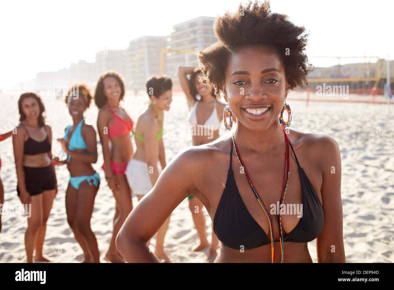 Women smiling together on beach Stock Photo