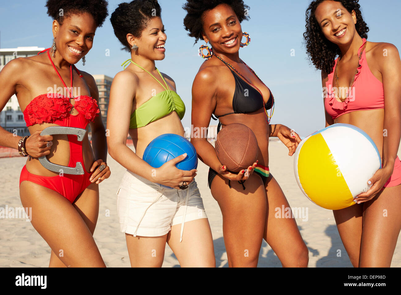 Women holding balls on beach Stock Photo - Alamy
