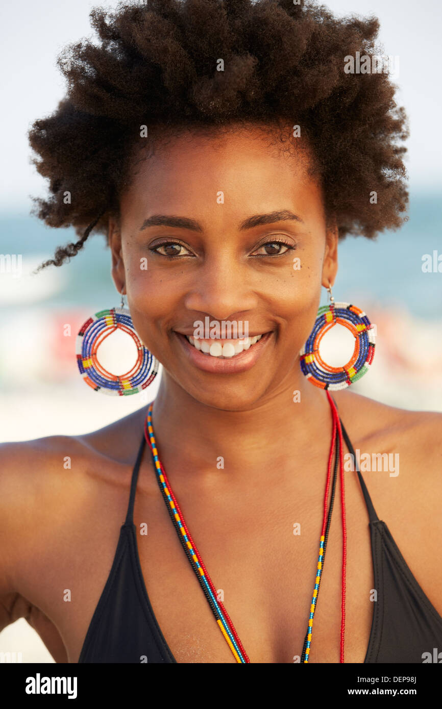 Black woman smiling on beach Stock Photo