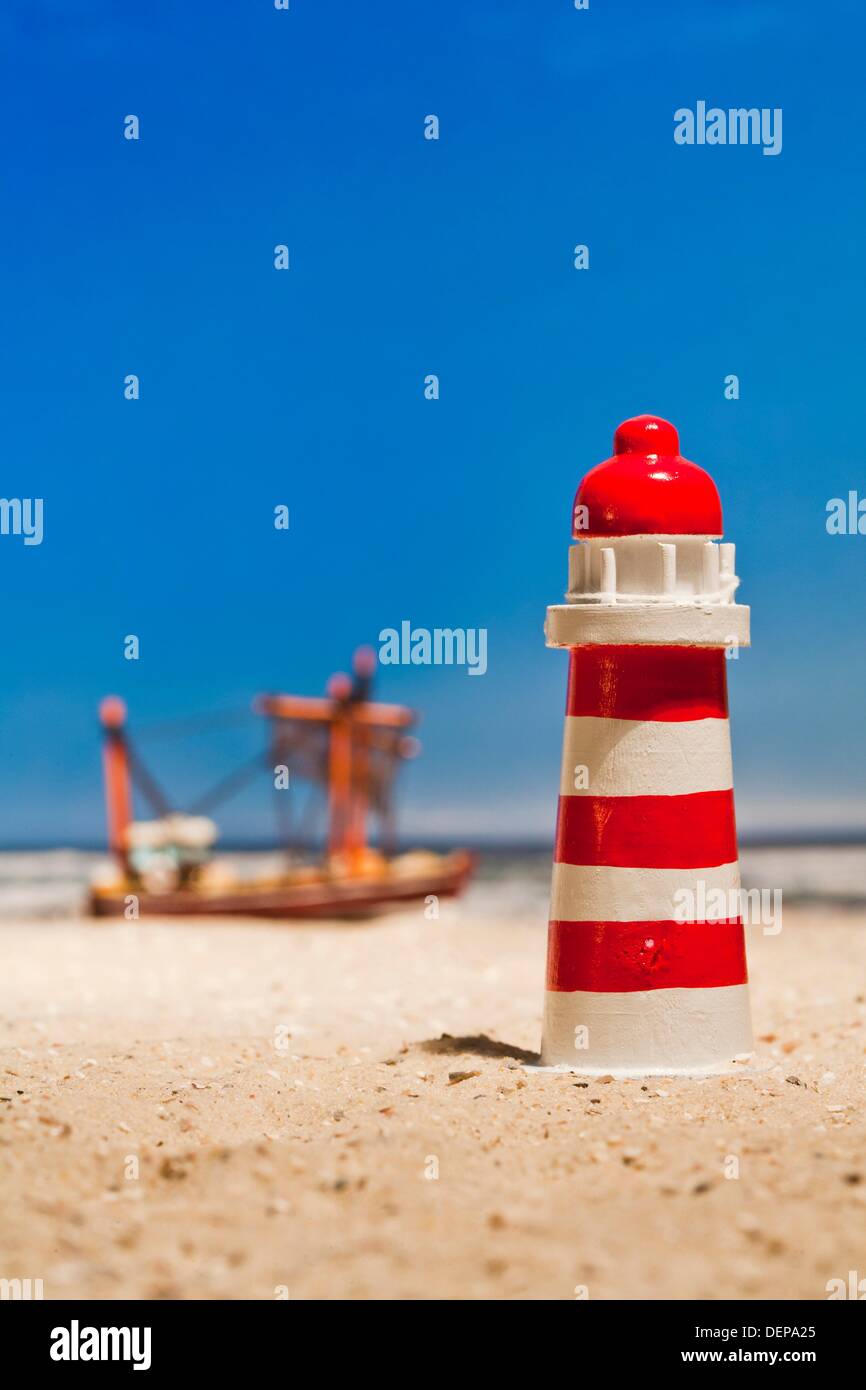 Still life of a miniature lighthouse and fishing boat Stock Photo Alamy