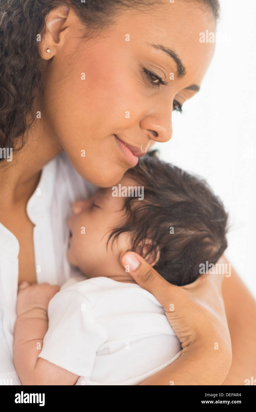 Hispanic mother holding infant son Stock Photo