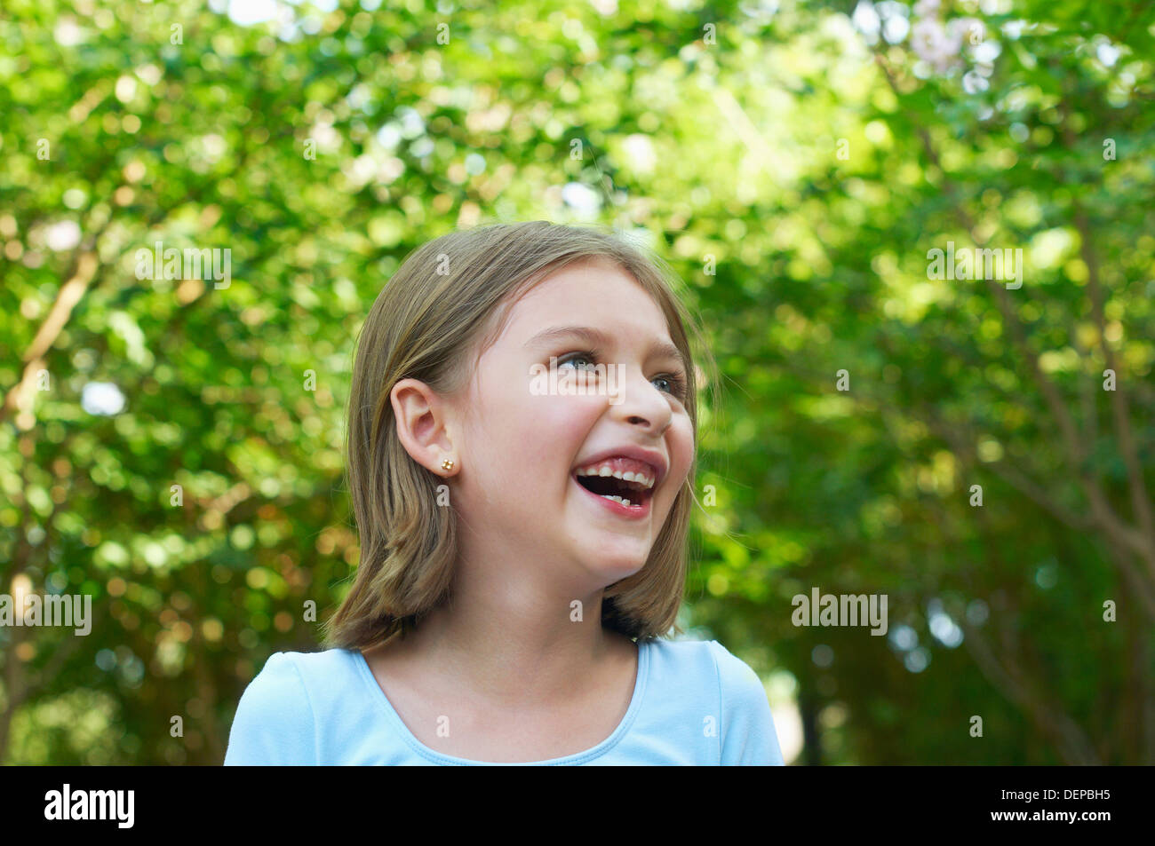 Hispanic girl laughing outdoors Stock Photo