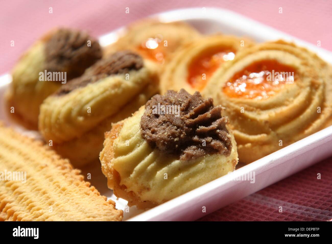 Piped chocolate and vanilla biscuits with jam filling Stock Photo Alamy