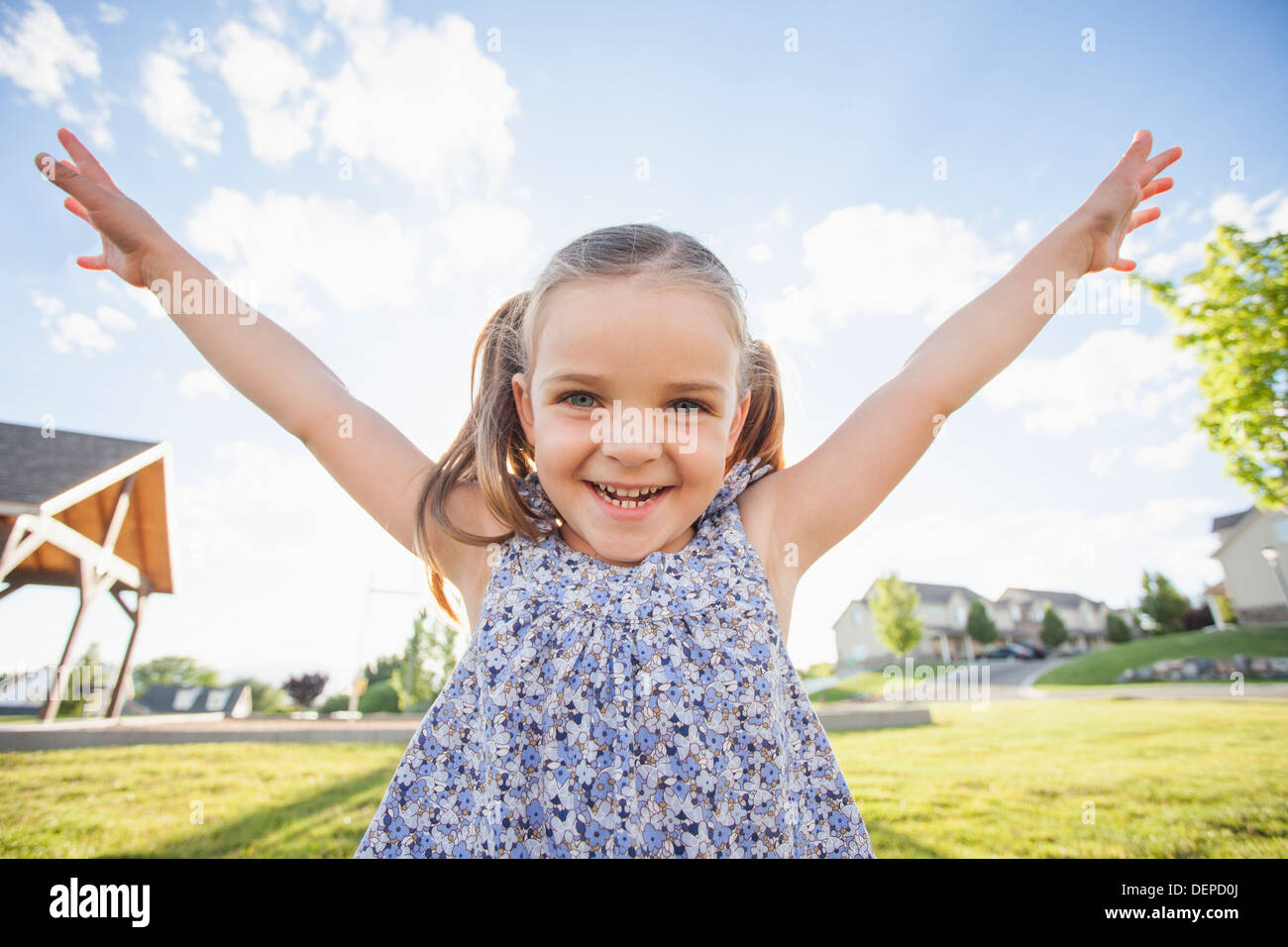 Caucasian girl playing outdoors Stock Photo