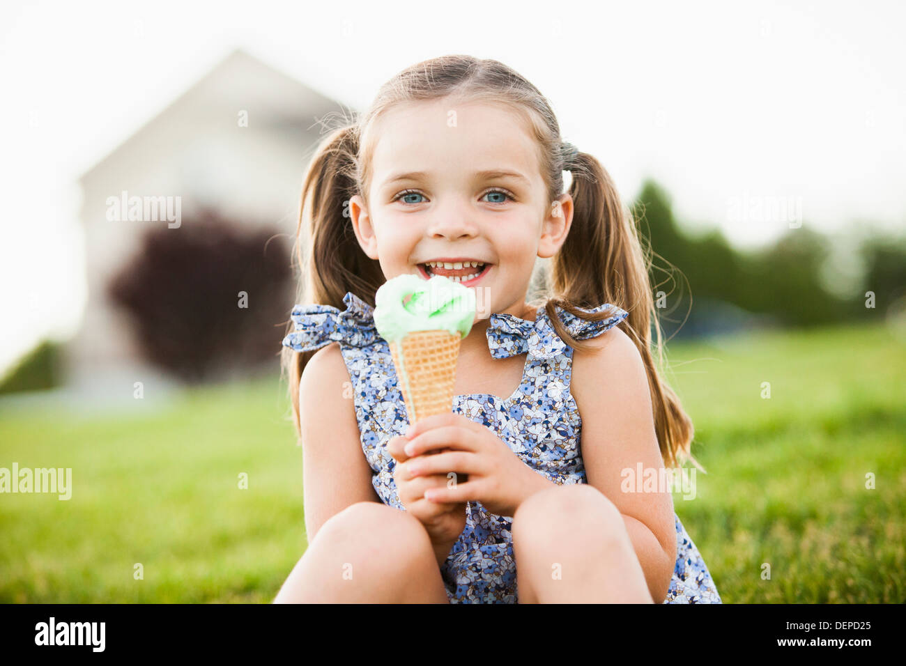 Caucasian girl eating ice cream outdoors Stock Photo