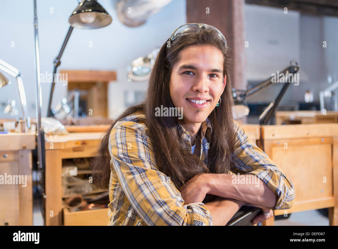 Mixed race man smiling in art studio Stock Photo