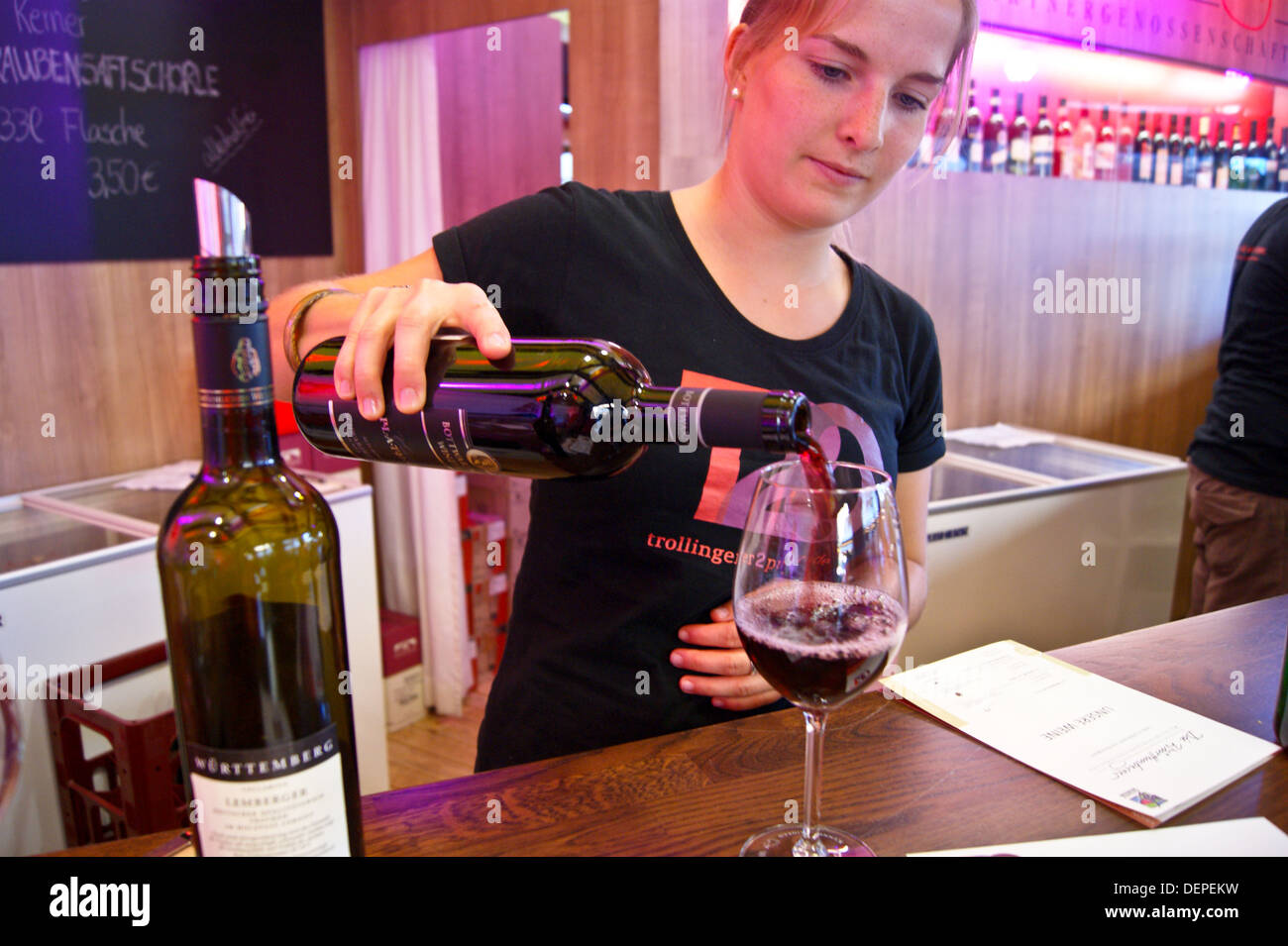 A girl pouring a glass of Schwarzriesling, WWG stall, Stuttgarter Weindorf, wine fair, Stuttgart, Baden-Wurttemburg, Germany Stock Photo
