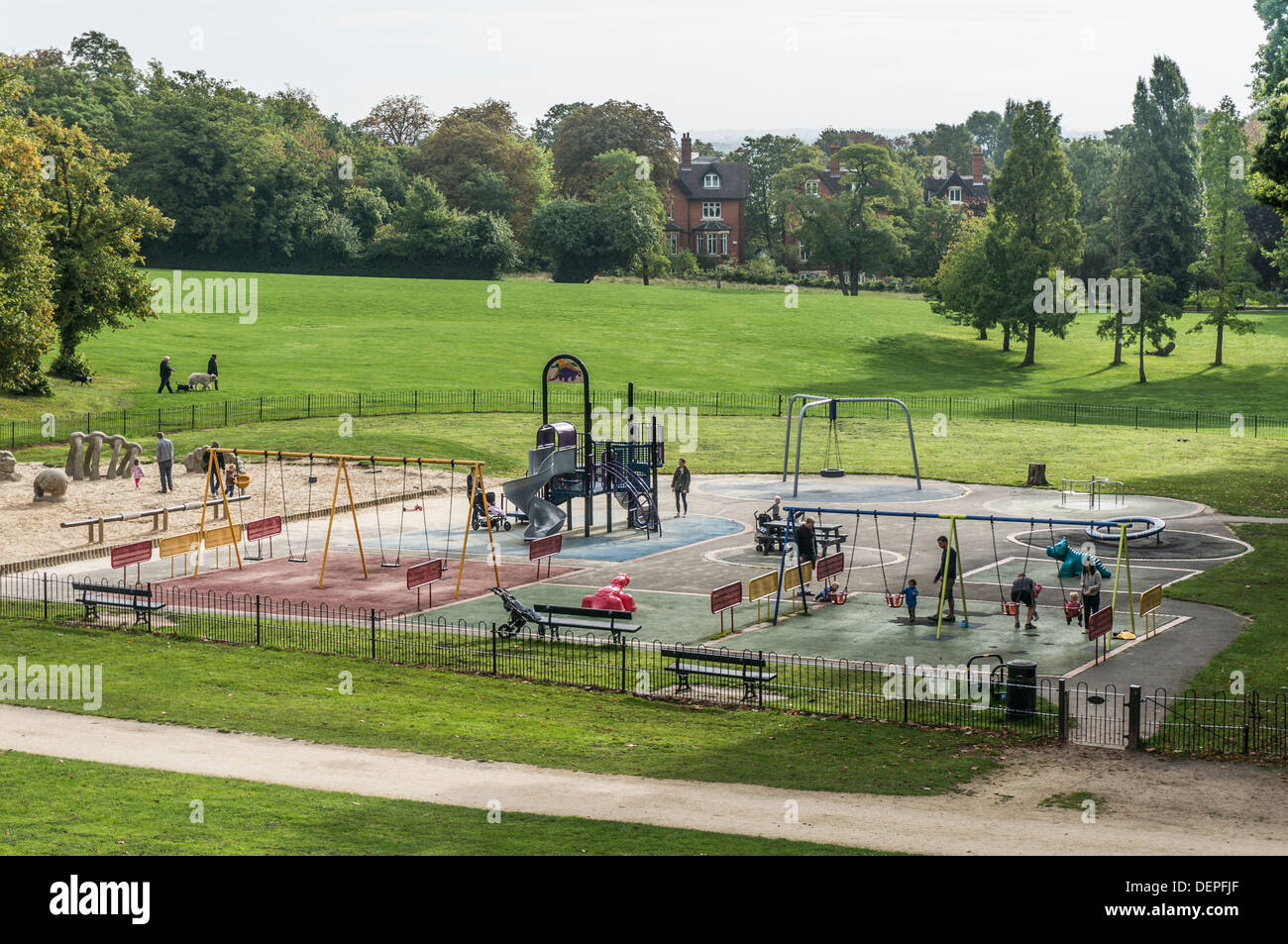 A busy children’s playground / play area with parents and young children enjoying a sunny autumn day in Crystal Palace park, London, England, UK. Stock Photo