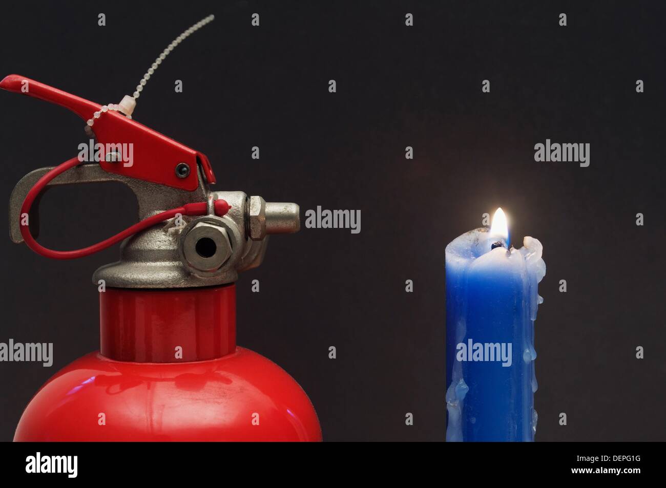 Fire extinguisher and candle Stock Photo Alamy