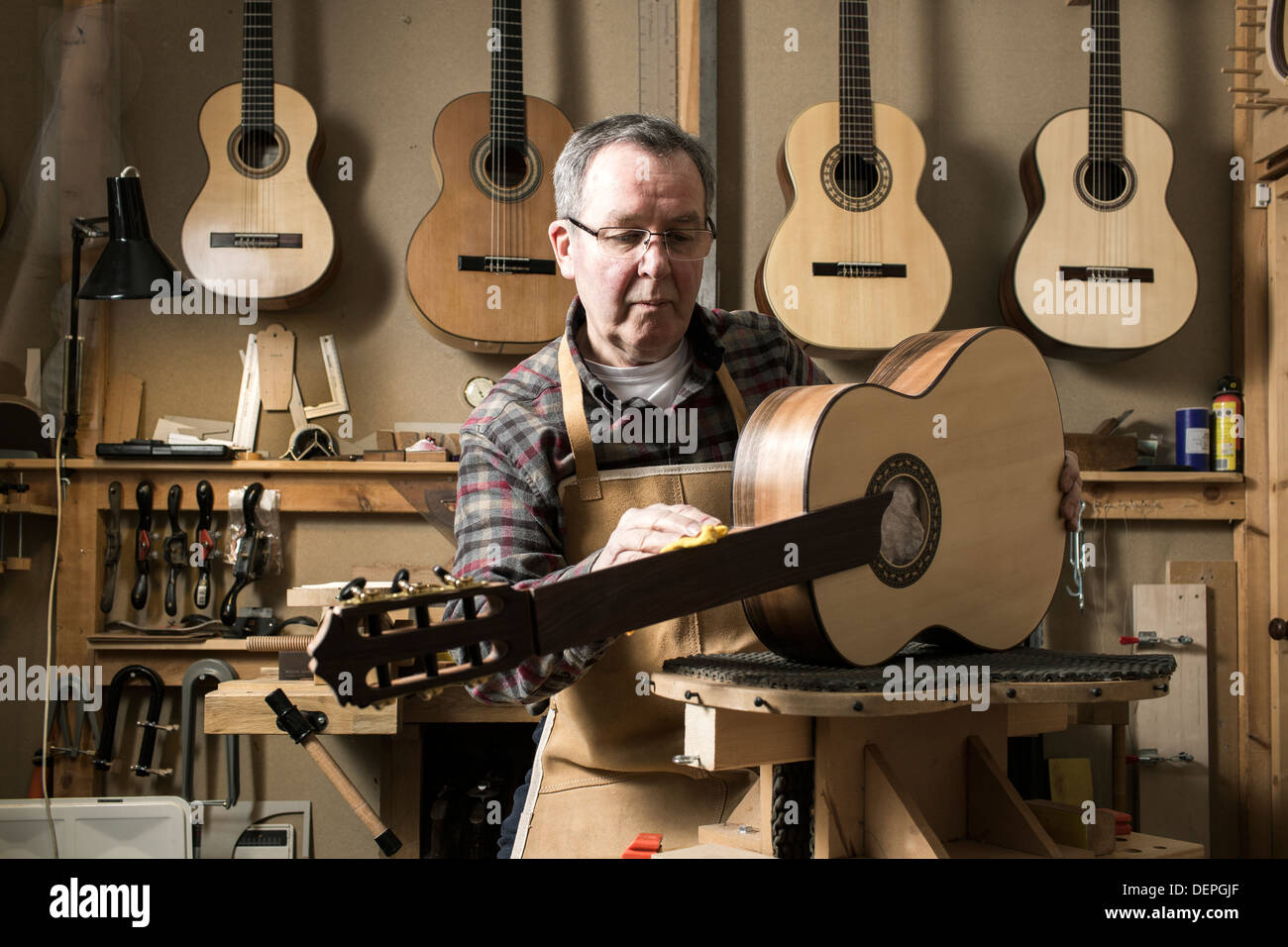 Guitar maker finishing acoustic guitar in Stock Photo Alamy