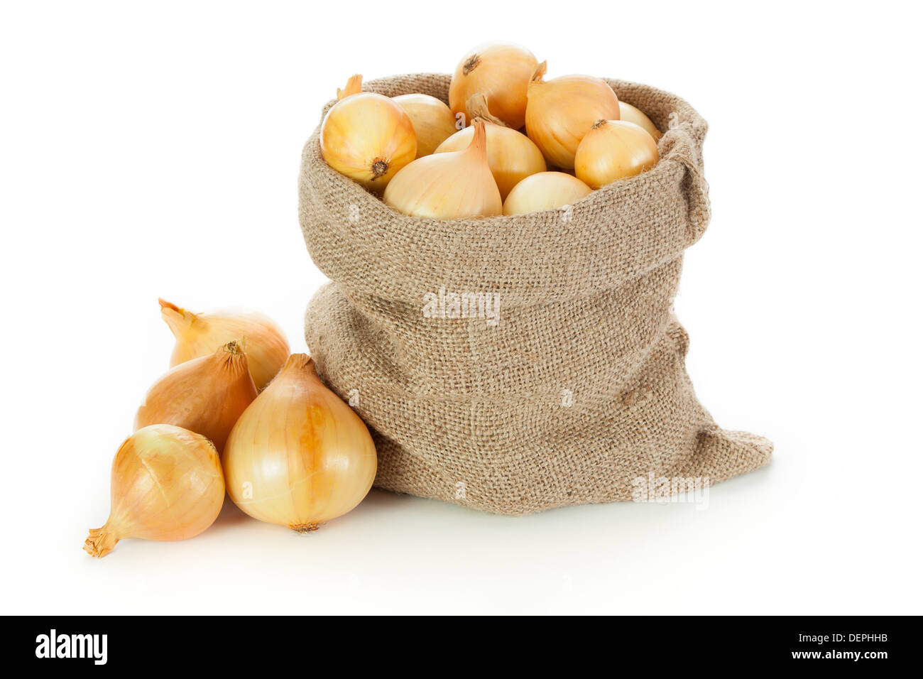 Onions in burlap sack on white background Stock Photo