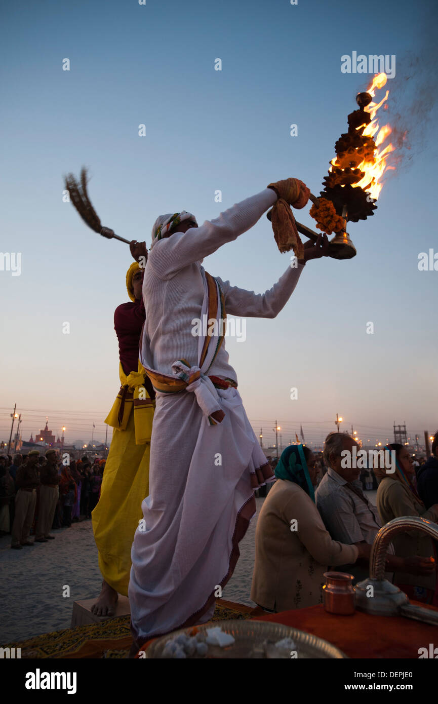 Priest performing evening aarti at Maha Kumbh, Allahabad, Uttar Pradesh, India Stock Photo