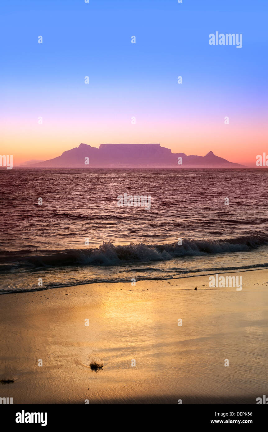 cape town from bloubergstrand at dusk sunset showing lights ocean and beach Stock Photo