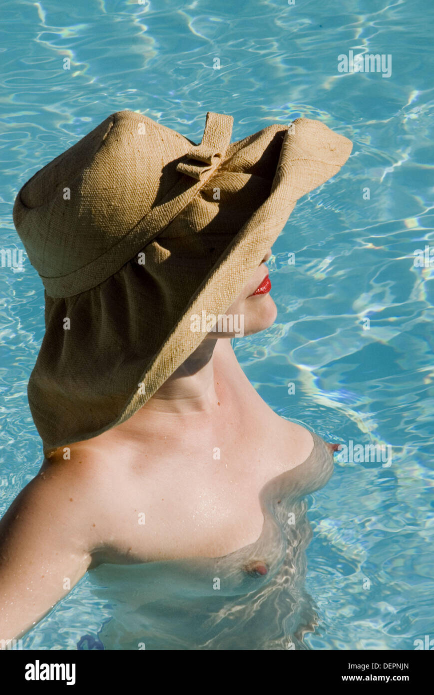 Top-less woman in swimming pool Stock Photo - Alamy