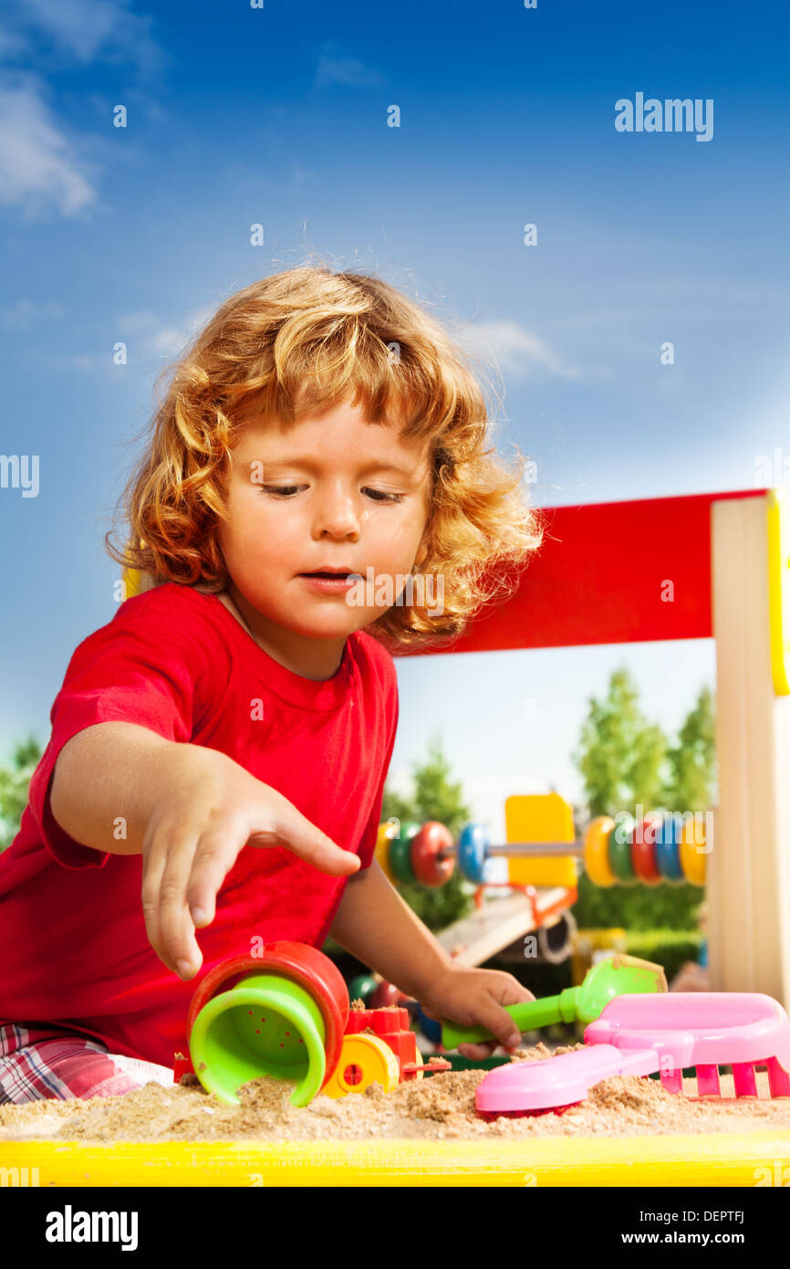 Happy little three years old child in playground playing with sand Stock Photo Alamy