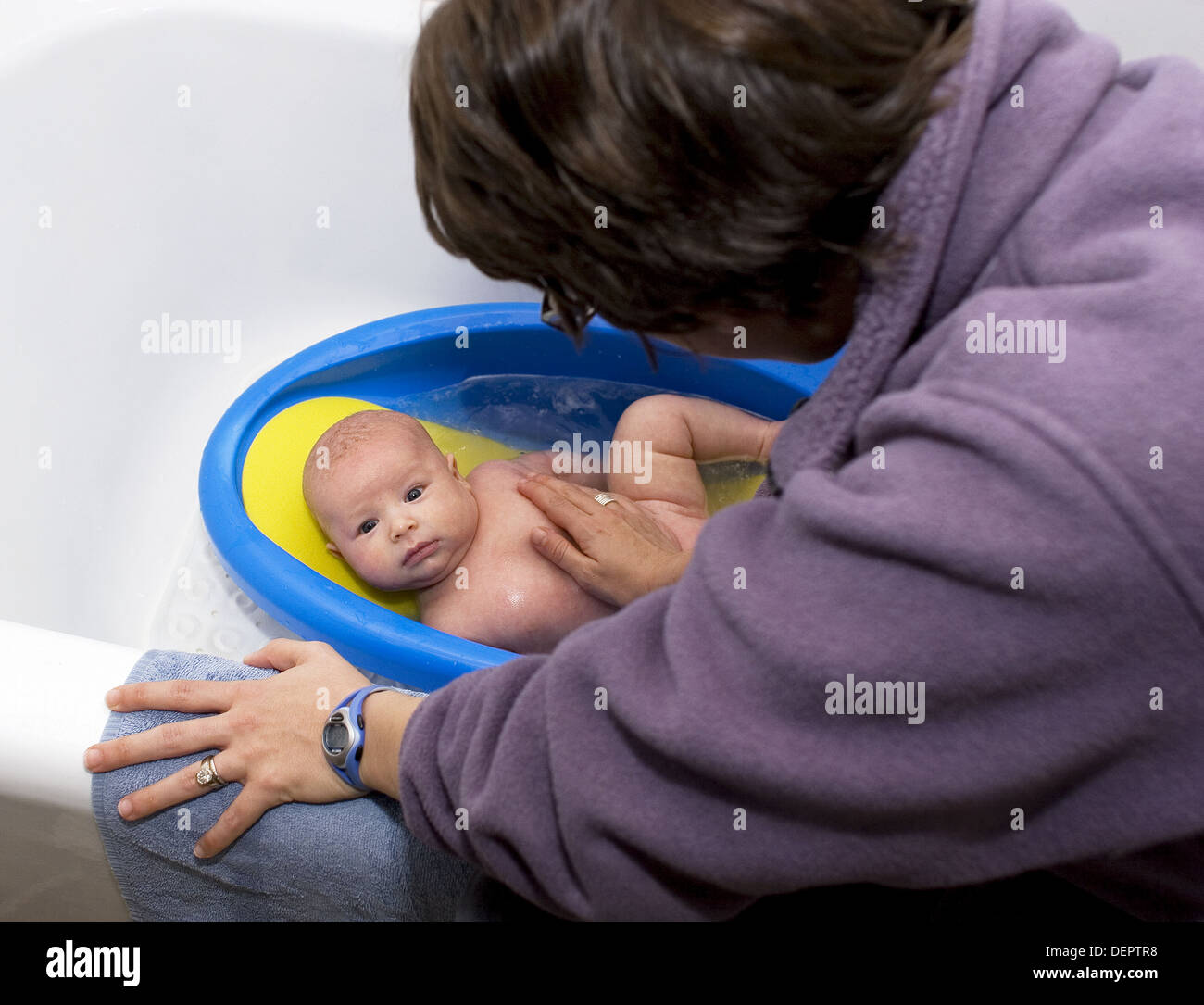 Mother giving three month old baby a bath Stock Photo Alamy