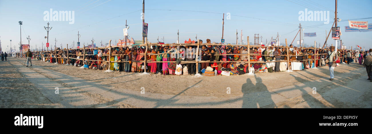 Crowd standing behind a fence along a path at Maha Kumbh, Allahabad, Uttar Pradesh, India Stock Photo