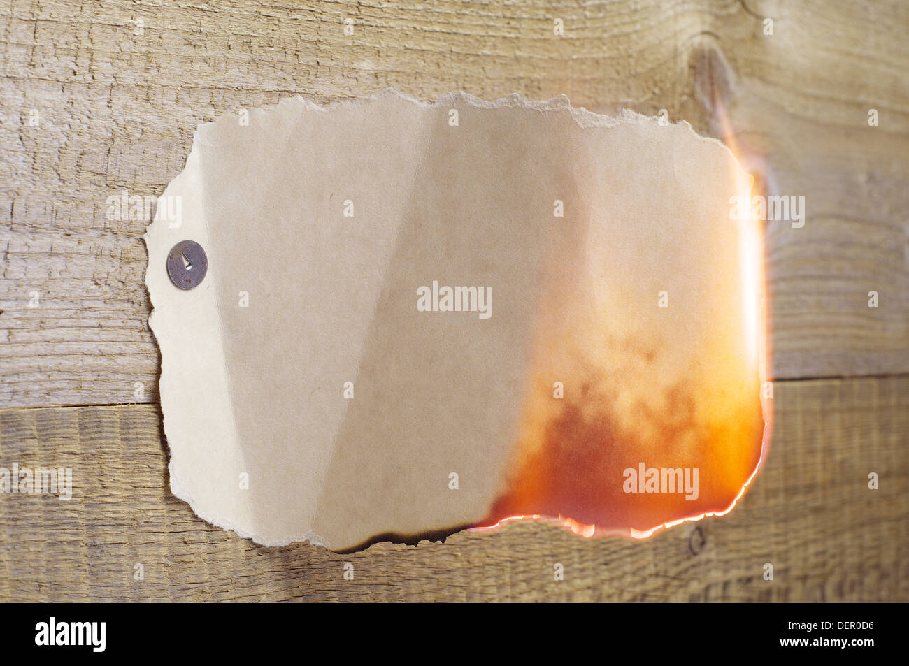 Burning paper on a wooden background Stock Photo