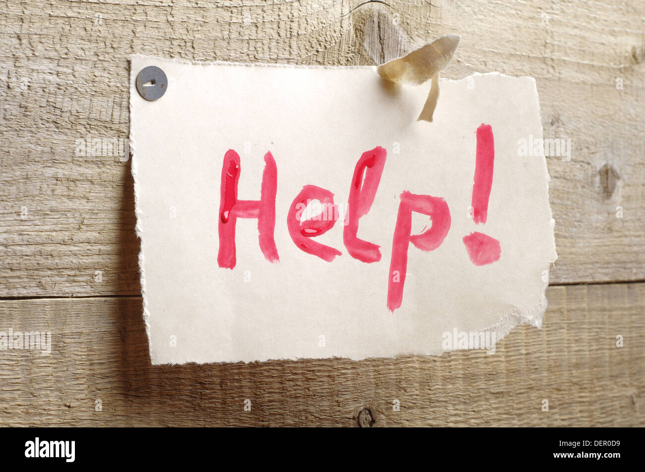 Sheet of torn paper with the words help on a wooden background Stock ...
