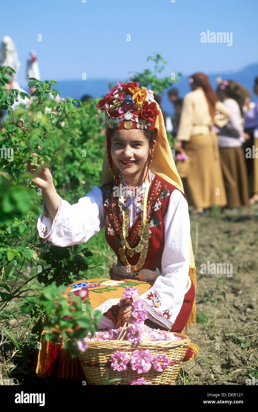 traditional dressed young girl in a rose garden during the Rose