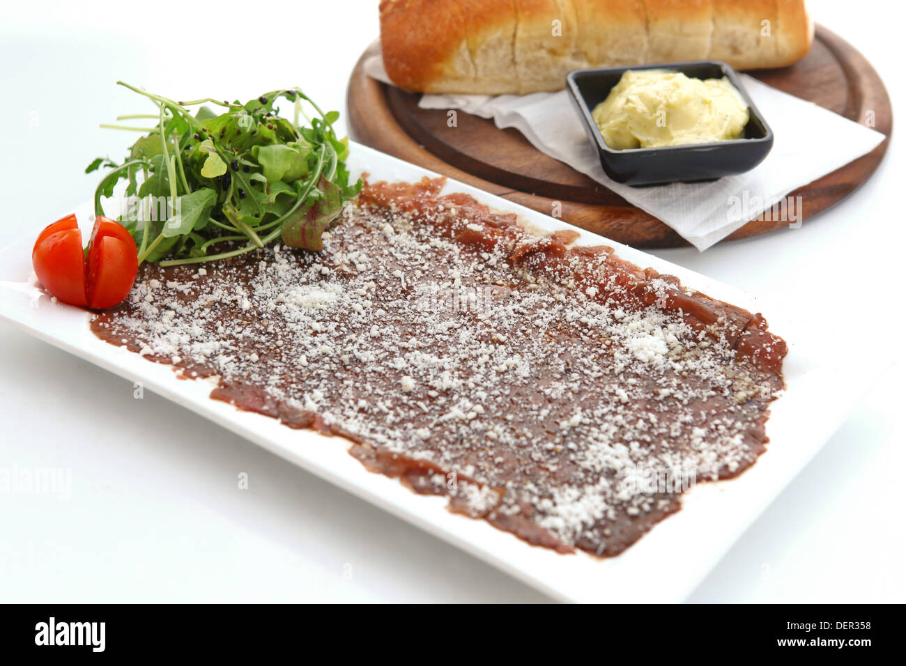 Beef carpaccio with Parmesan Cheese bread and butter Stock Photo