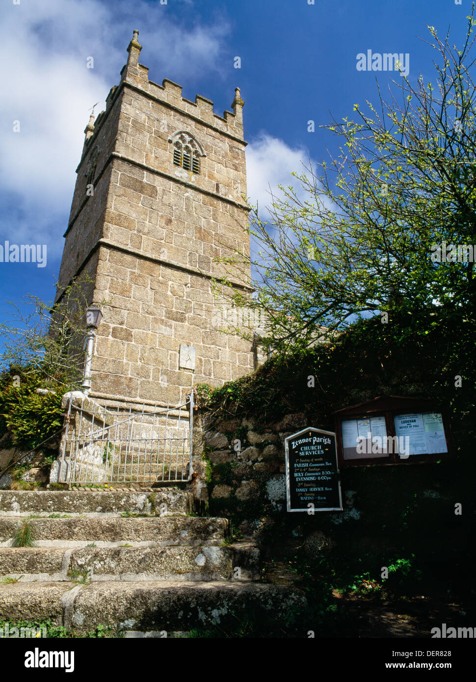 Looking up at the churchyard steps and wall, and the C15th Cornish, Perpendicular Gothic, granite ashlar tower of St Senara's Church, Zennor. Stock Photo