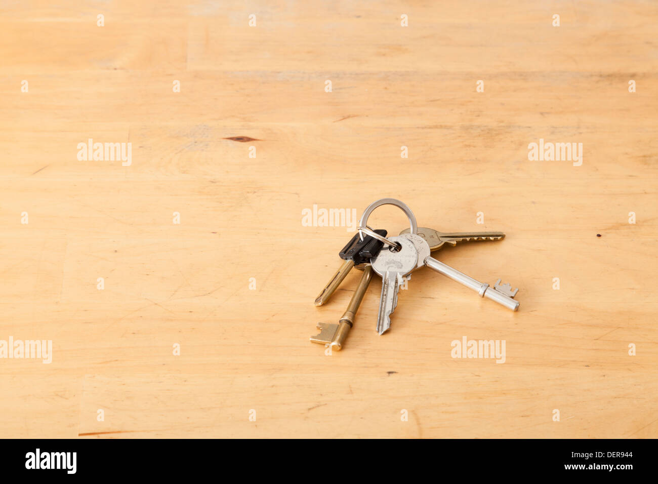 Small bunch of keys on a key ring left on a table Stock Photo