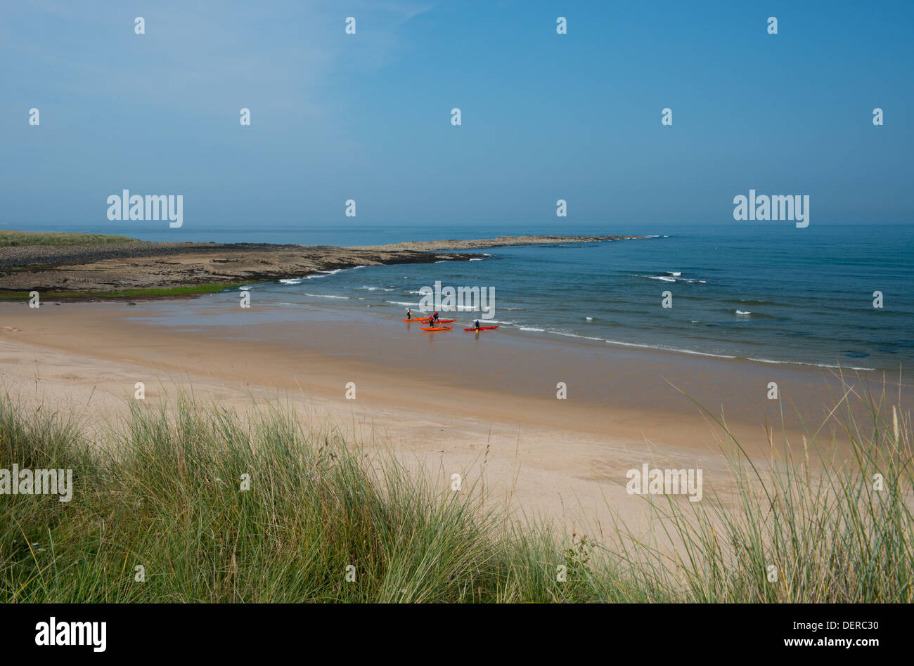 Kayakers on the beach at Football Hole near Low NewtonbytheSea, Northumberland, UK Stock