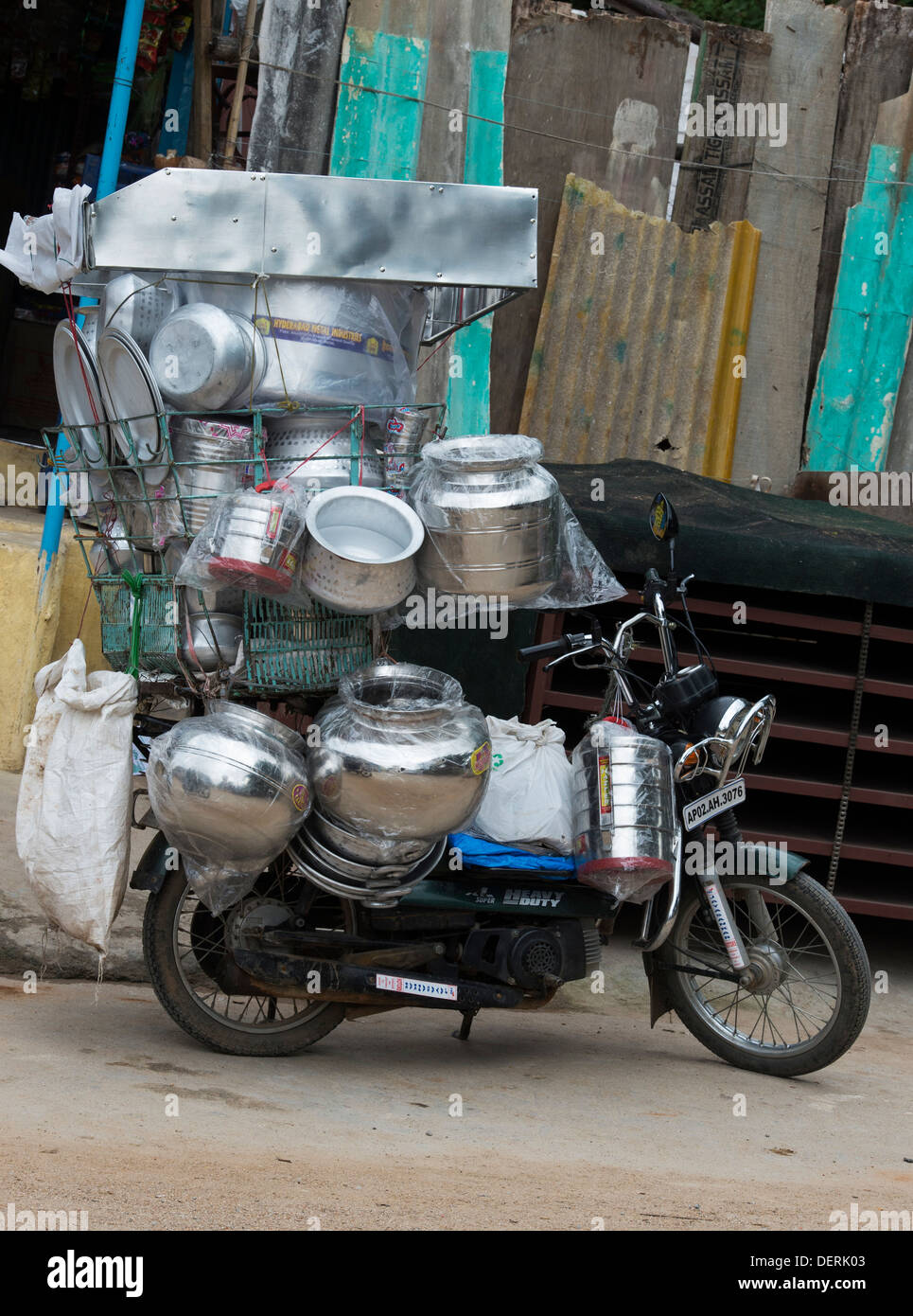 Indian moped ladened with kitchenware to sell to local shops. Andhra Pradesh, India Stock Photo