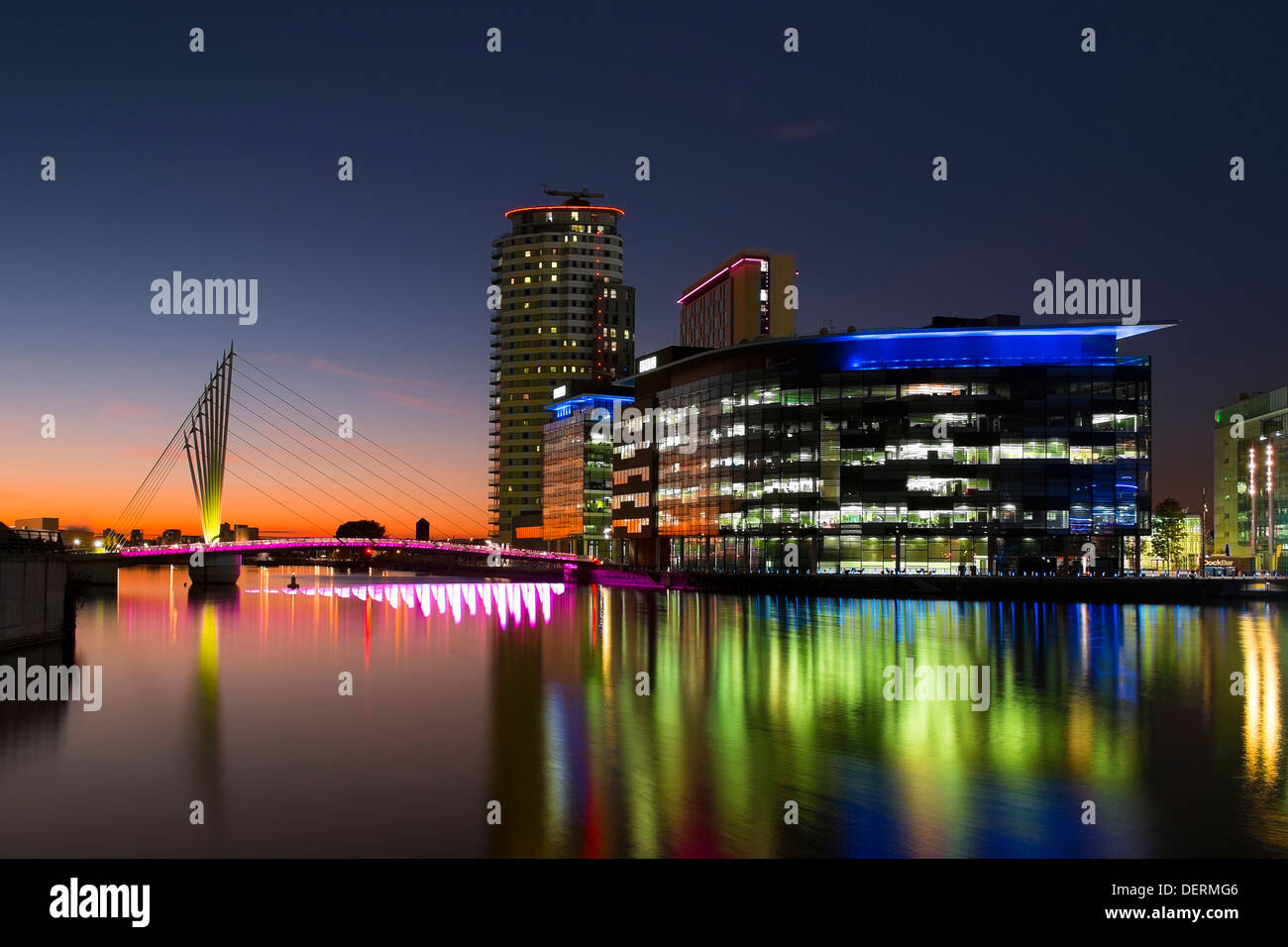 England, Greater Manchester, Salford Quays, Media City illuminated at sunset Stock Photo
