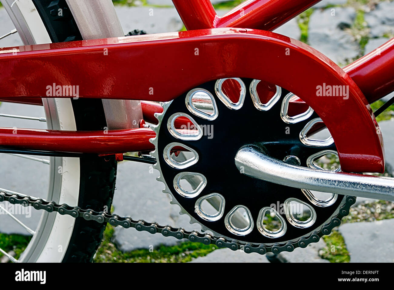 Detail of bicycle crank, chain, derailleur, red mudguards and rear wheel. Stock Photo