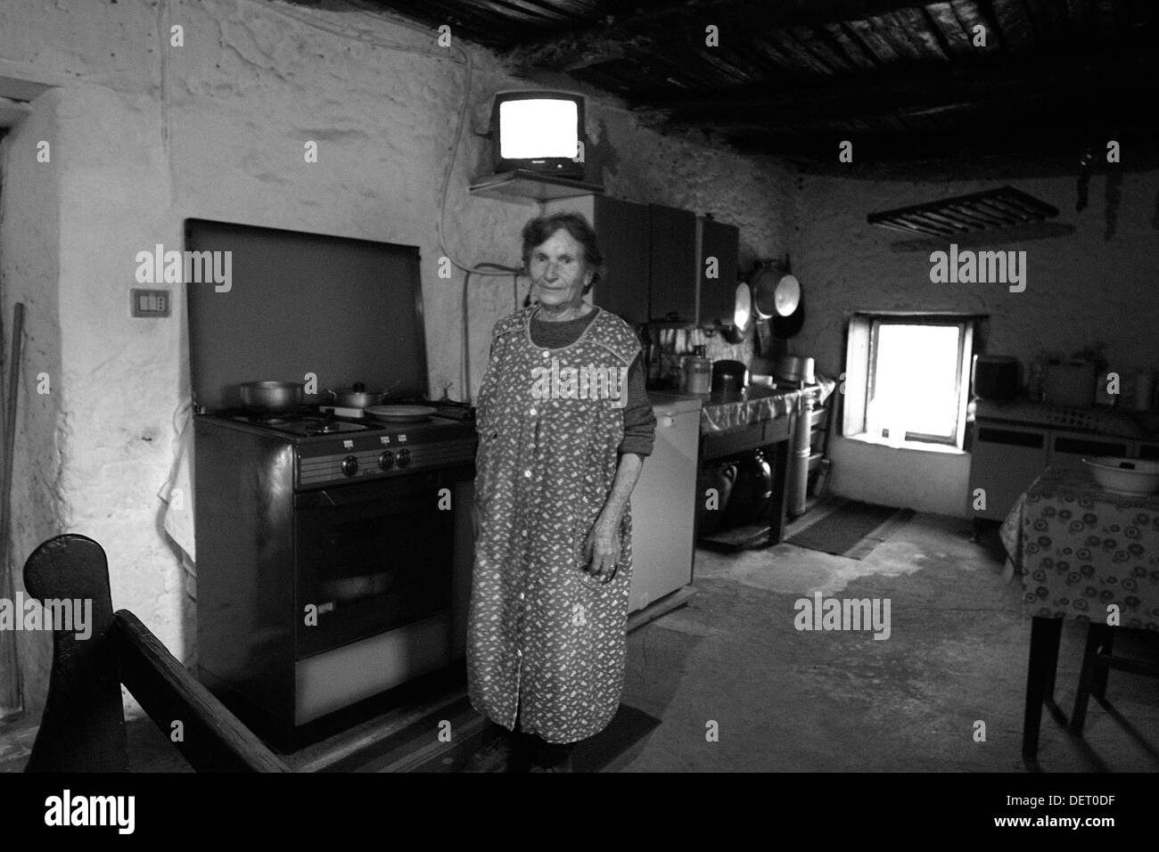 Woman in her rustic kitchen, Campania, Italy Stock Photo
